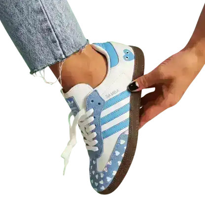 Special 2026 edition Adidas Samba trainers featuring a cute blue heart motif, a lovely addition to any fashion-forward wardrobe.