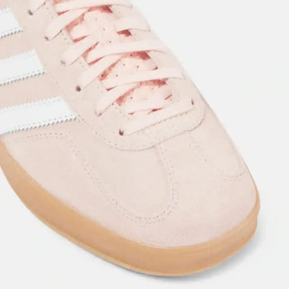 Close-up detail of Adidas Gazelle light pink suede material and gum sole
